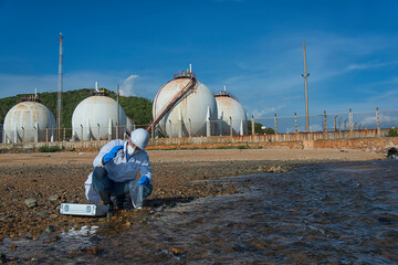 Researchers, scientists in protective clothing use water for analysis from polluted rivers.
