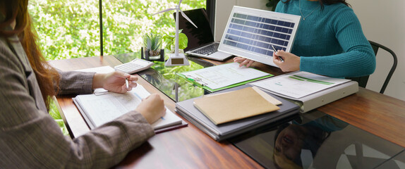 Solar panels green energy Business people working in green eco friendly office business meeting...