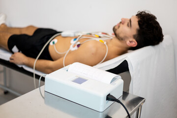 An electrocardiogram procedure for diagnosing heart disease in a hospital ward. The...