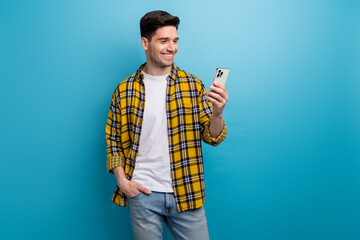 Photo of cheerful charming guy wear yellow checkered shirt texting instagram twitter telegram...
