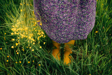 bouquet of buttercups and yellow boots