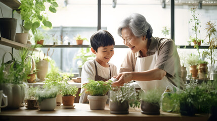 Naklejka premium Asian grandmother and her grandchild planting together. World plant day concept.