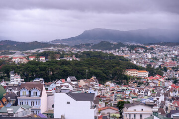 View on roofs in the city of Dalat. Da Lat and the surrounding area is a popular tourist destination of Asia. City with fogs and mountains