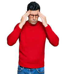 Handsome hispanic man wearing casual clothes and glasses with hand on head for pain in head because stress. suffering migraine.