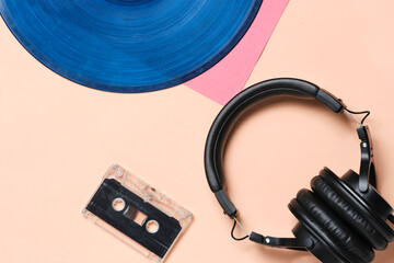 Background, old retro vinyl records, headphones and an audio cassette.
