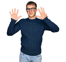 Young blond man wearing casual clothes and glasses showing and pointing up with fingers number nine...
