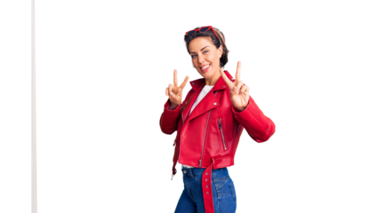 Young beautiful woman wearing red leather jacket smiling looking to the camera showing fingers doing victory sign. number two.