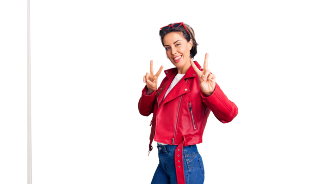 Young beautiful woman wearing red leather jacket smiling looking to the camera showing fingers doing victory sign. number two.