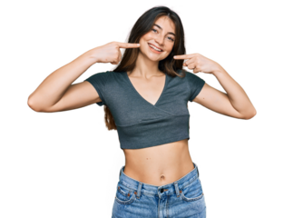Young beautiful teen girl wearing casual crop top t shirt smiling cheerful showing and pointing with fingers teeth and mouth. dental health concept.