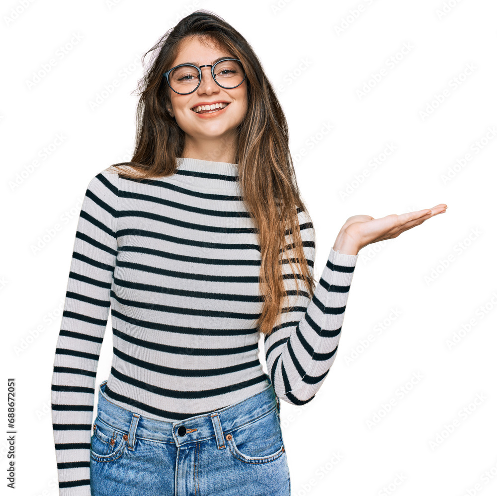 Wall mural young beautiful teen girl wearing casual clothes and glasses smiling cheerful presenting and pointin