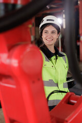 Female automation engineer wear vest with helmet safety checking and inspection control robot arm welding machine in an industrial factory. Artificial intelligence concept.