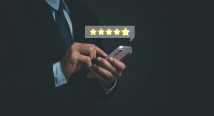 Customer experience review giving 5 star, man hand pressing on smartphone screen with five-star...