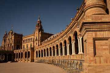 Naklejka premium The National Geographic Institute in Plaza de España Seville city Spain. Central government offices in stunning rich wealthy architecture design on sunny day. Impressive symmetrical masonry 