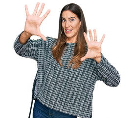 Young beautiful woman wearing casual clothes afraid and terrified with fear expression stop gesture with hands, shouting in shock. panic concept.