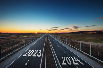Driving on open road at beautiful sunny day to new year 2024 Aerial view