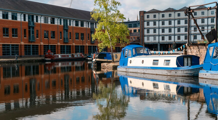 discovering hidden treasures of old English city.  Magnificient view on chanel canal quays with long boats on a calm day