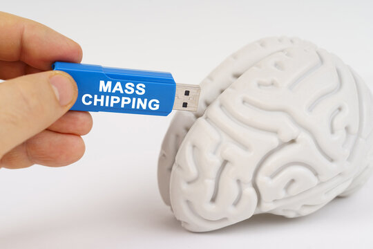 A man inserts a flash drive into his brain with the inscription - mass chipping - Powered by Adobe