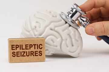 Using a stethoscope, the brain is diagnosed, next to it is a sign with the inscription - epileptic...