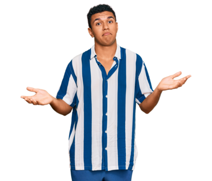 Young arab man wearing casual clothes clueless and confused expression with arms and hands raised. doubt concept.