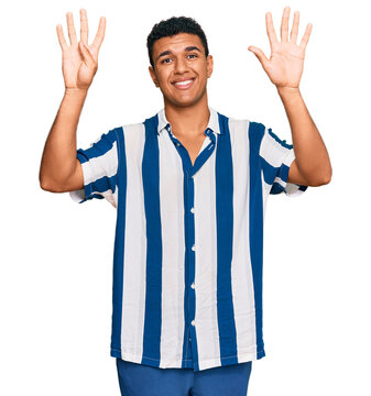 Young arab man wearing casual clothes showing and pointing up with fingers number nine while smiling confident and happy.