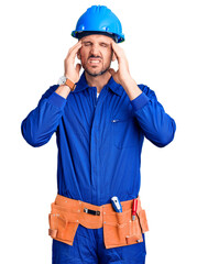 Young handsome man wearing worker uniform and hardhat touching forehead for illness and fever, flu and cold, virus sick