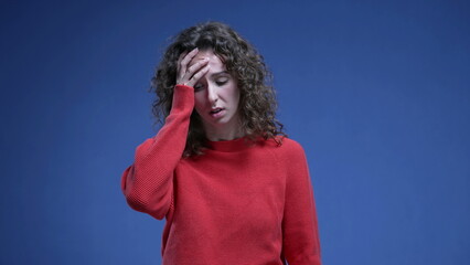 Woman covering face with regret, anxious preoccupied 20s person feeling anguish and annoyance...