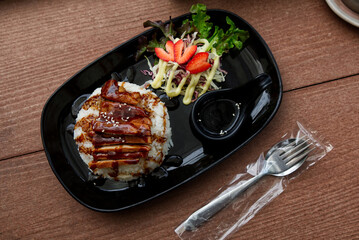 Steamed Jasmine Rice Paired with Fried Pork and Delicious Japanese-Style Dipping Sauce, Served on the Dining Table.
