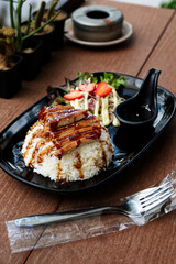 Steamed Jasmine Rice Paired with Fried Pork and Delicious Japanese-Style Dipping Sauce, Served on the Dining Table.