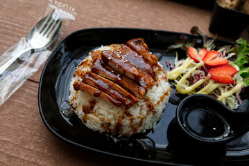 Steamed Jasmine Rice Paired with Fried Pork and Delicious Japanese-Style Dipping Sauce, Served on the Dining Table.