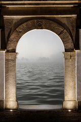 View of the sea through the ancient stone gate leading to the nearby waterfront port.
