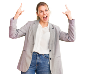 Young beautiful blonde woman wearing elegant jacket shouting with crazy expression doing rock symbol with hands up. music star. heavy music concept.