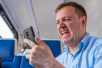 Bewildered man gazes at screen of smartphone, encountering content that confuses him or contains...