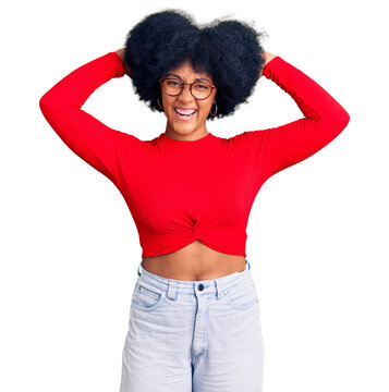 Young african american girl wearing casual clothes and glasses relaxing and stretching, arms and hands behind head and neck smiling happy