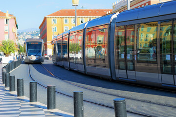 Obraz premium Trams in the center of Nice, France. Reflection of buildings in the windows of the tramway.