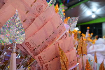 100 Thai Baht bank notes as money to be donated for merit making in Kathina ceremony.