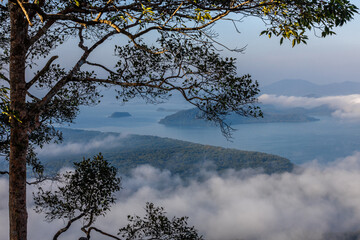 High-angle natural background from a vantage point, overlooking the sun's rays blurred in the morning in the middle of the sea, is a beautiful glowing golden light of nature that can't be seen much.