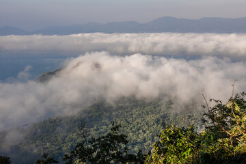 High-angle natural background from a vantage point, overlooking the sun's rays blurred in the morning in the middle of the sea, is a beautiful glowing golden light of nature that can't be seen much.