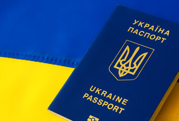 Ukrainian passport against the background of the Ukrainian flag.