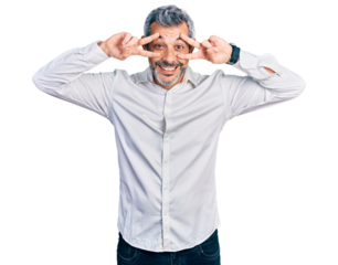 Middle age hispanic with grey hair wearing casual white shirt doing peace symbol with fingers over face, smiling cheerful showing victory