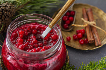 A glass jar of tasty  lingonberry Jam. Preserved berries, homemade jam, Nordic berry jam, antioxidant Superfood