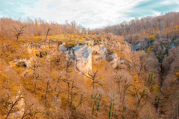 Fototapeta premium Forested mountains and a gorge below. Lago Naki plateau in autumn. Beautiful natural landscape