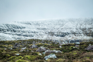 snowy mountain hill with rocks