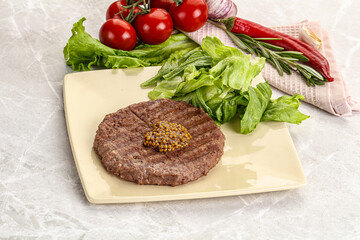 Frilled beef burger cutlet with iceberg