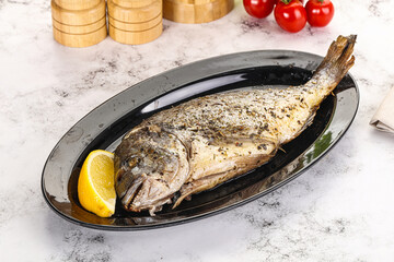 Baked Dorado fish served lemon