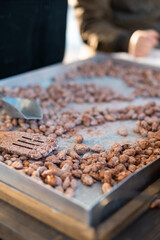 Candied caramelized almond. on the hot searing pan being freshly made on a holiday market in scandinavia