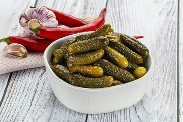 Marinated small cucumbers in the bowl