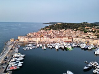 Row of Super yachts moored Saint Tropez port France evening drone aerial