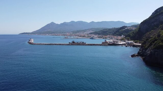 Aerial footage of shipyard in Karlovasi, Samos island behind wave breakers on a clear summer morning