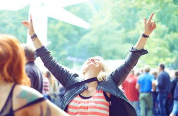 Woman, dancing and happy outdoor at music festival for freedom, performance and entertainment with crowd. Person, cheering and smile at event, concert or show with audience in nature for summer party - obrazy, fototapety, plakaty