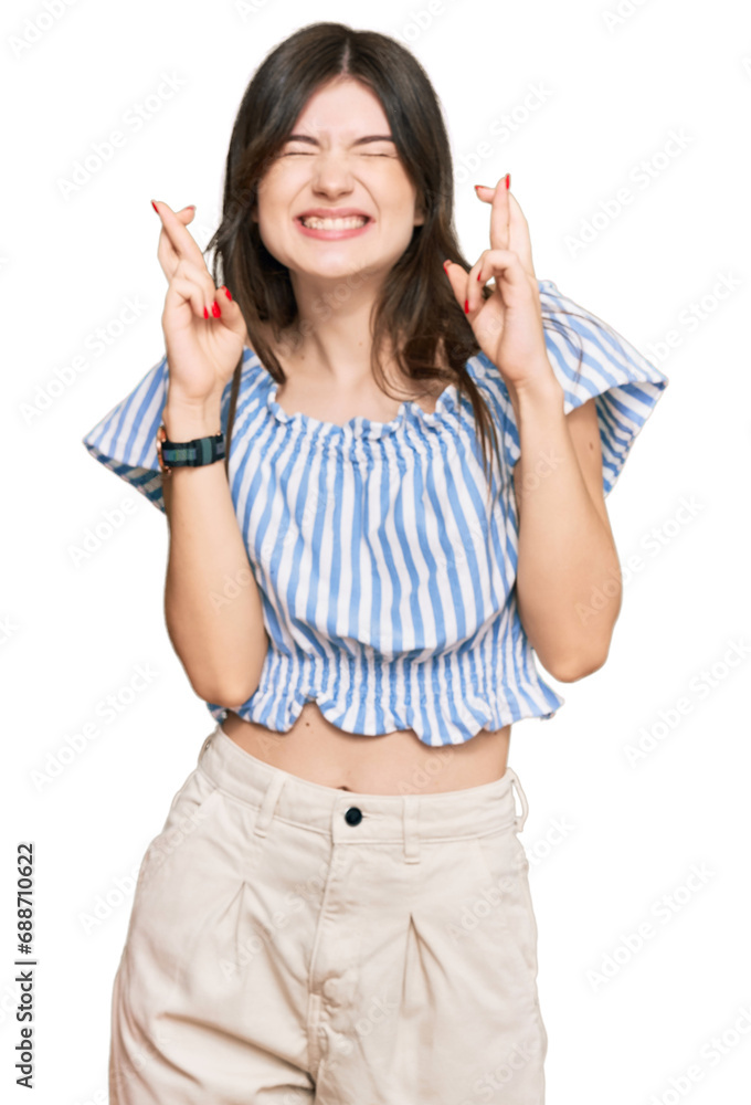 Sticker young beautiful caucasian girl wearing casual clothes gesturing finger crossed smiling with hope and